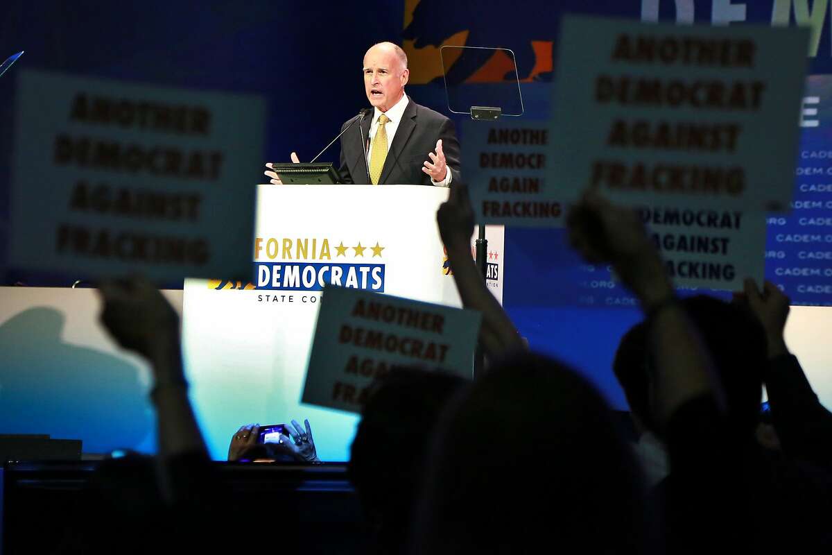 Gov. Jerry Brown addresses the California Democratic Convention as anti fracking protestors demonstrate during his speech in Los Angeles, California March 8, 2014. photo/Jonathan Alcorn for the Chronicle
