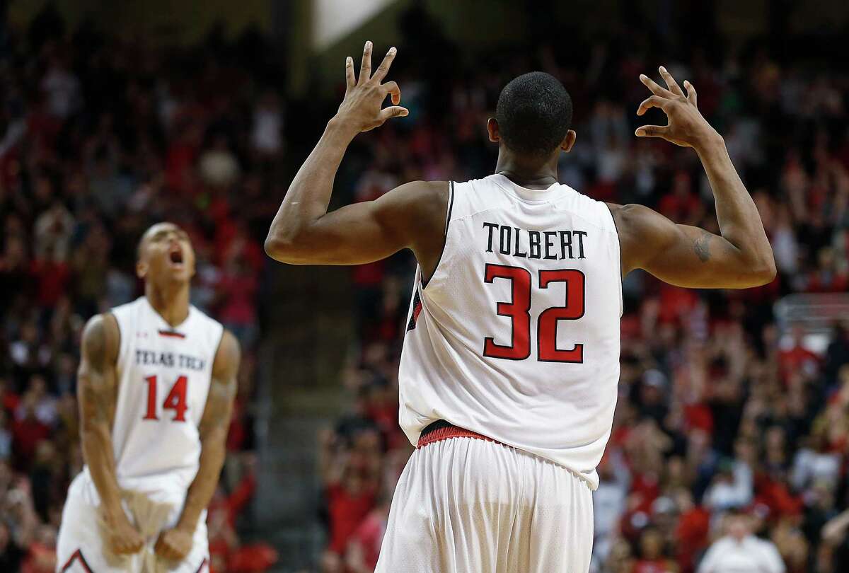 Texas Tech's Jordan Tolbert (32) gets an assist from teammate Robert Turner (14) as they celebrate Tolbert's 3-pointer against Texas on Saturday.