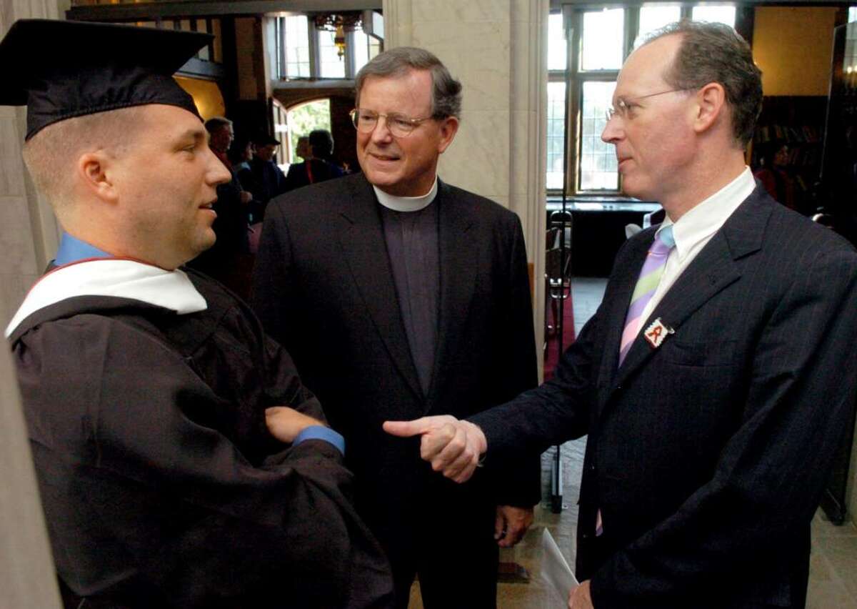 Douglas Perlitz and Fairfield University President Rev. Jeffrey von Arx, talk with Dr. Paul Farmer in the hallway at Bellarmine Hall prior to the 2006 Fall Convocation.