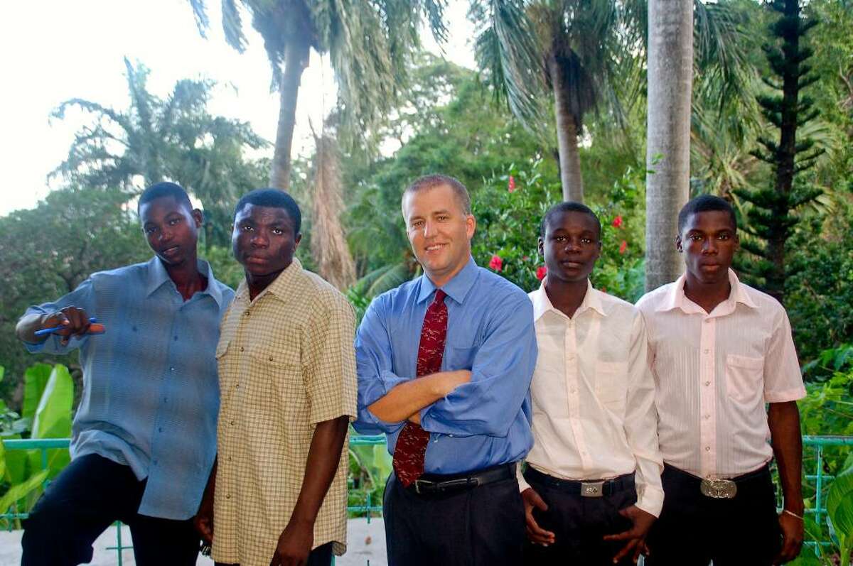 Douglas Perlitz, center, in Haiti, at The Village with some of the boys from the Project Pierre Toussaint, a program in Cap-Haitien designed to give a future to boys with none.