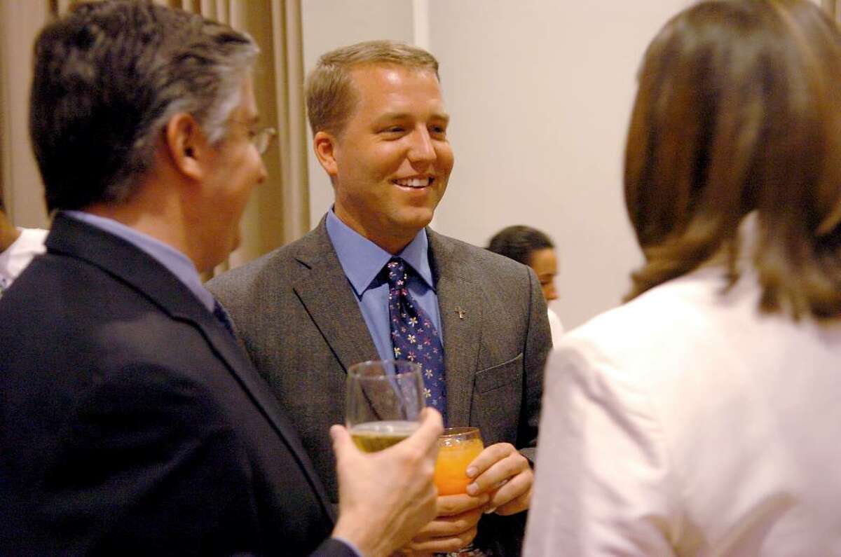Douglas Perlitz, Executive Director of Project Toussaint in Haiti, talks with guests at the "Jazz it up for Haiti " benefit event at Fairfield University in March 2006.