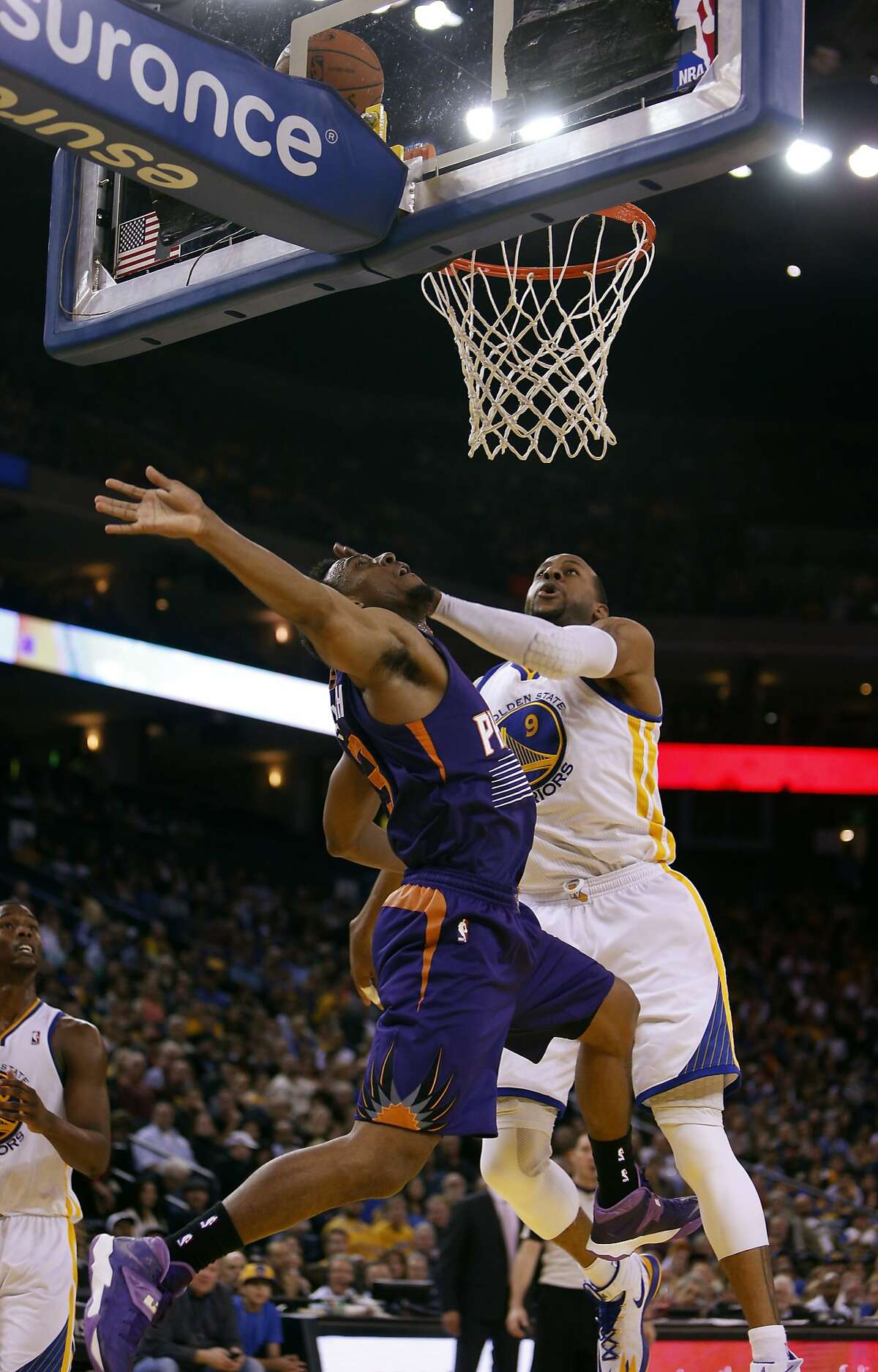 Andre Iguodala defends against Ish Smith in the second half. The Golden State Warriors played the Phoenix Suns at Oracle Arena in Oakland, Calif., on Sunday, March 9, 2014.
