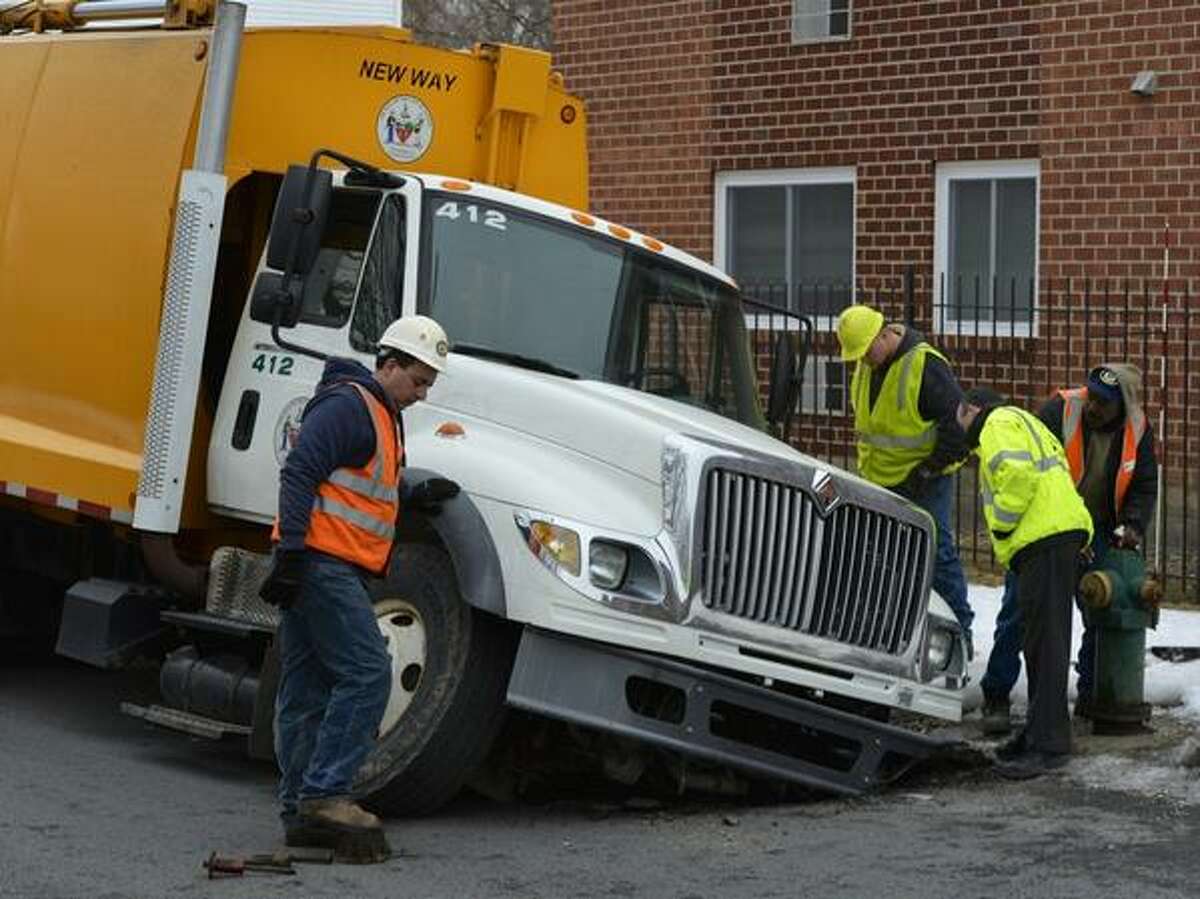 Garbage truck stuck in Albany sinkhole