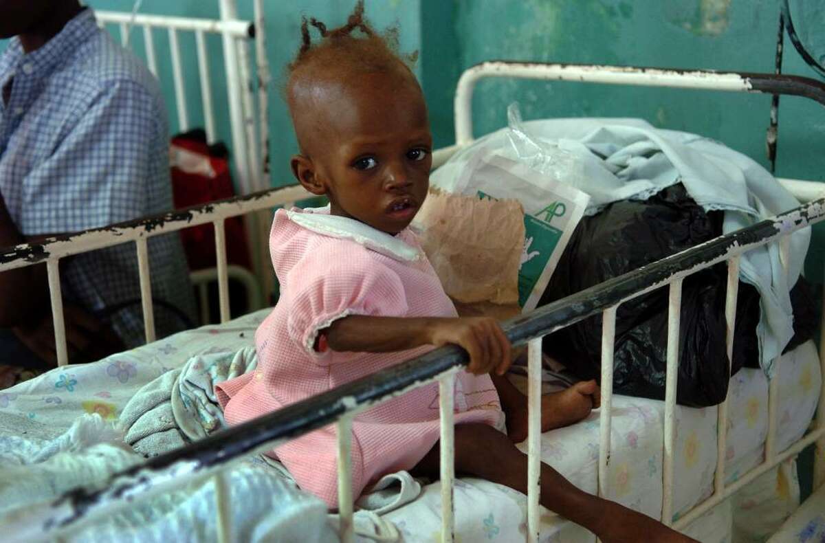 A young child sits in her crib at Justinien Hospital's pediatric ward, in downtown Cap-Haitien on Wednesday Dec. 16, 2009.