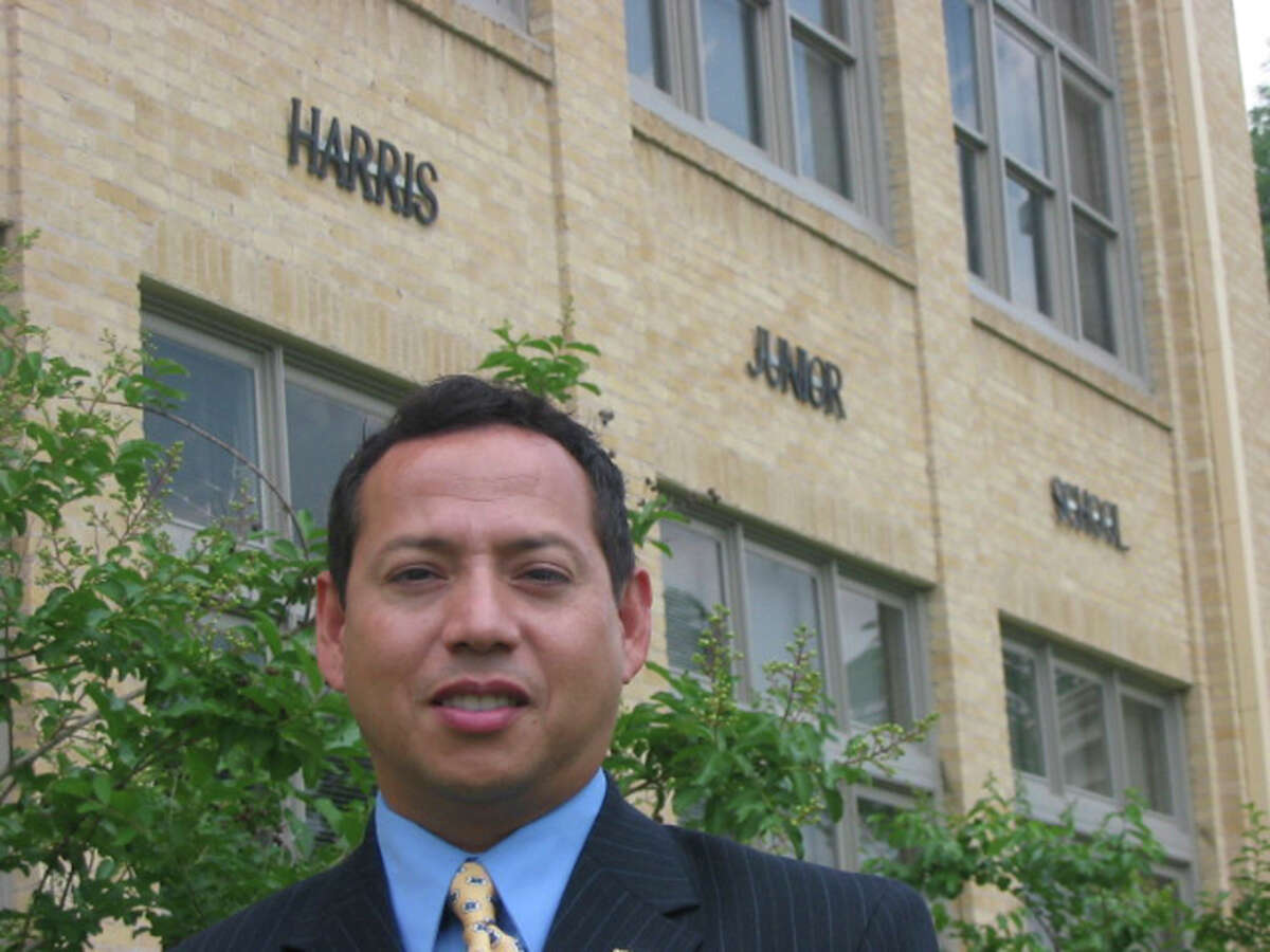 Former Harris Middle School Principal Moises Ortiz stands in front of the school in 2006.