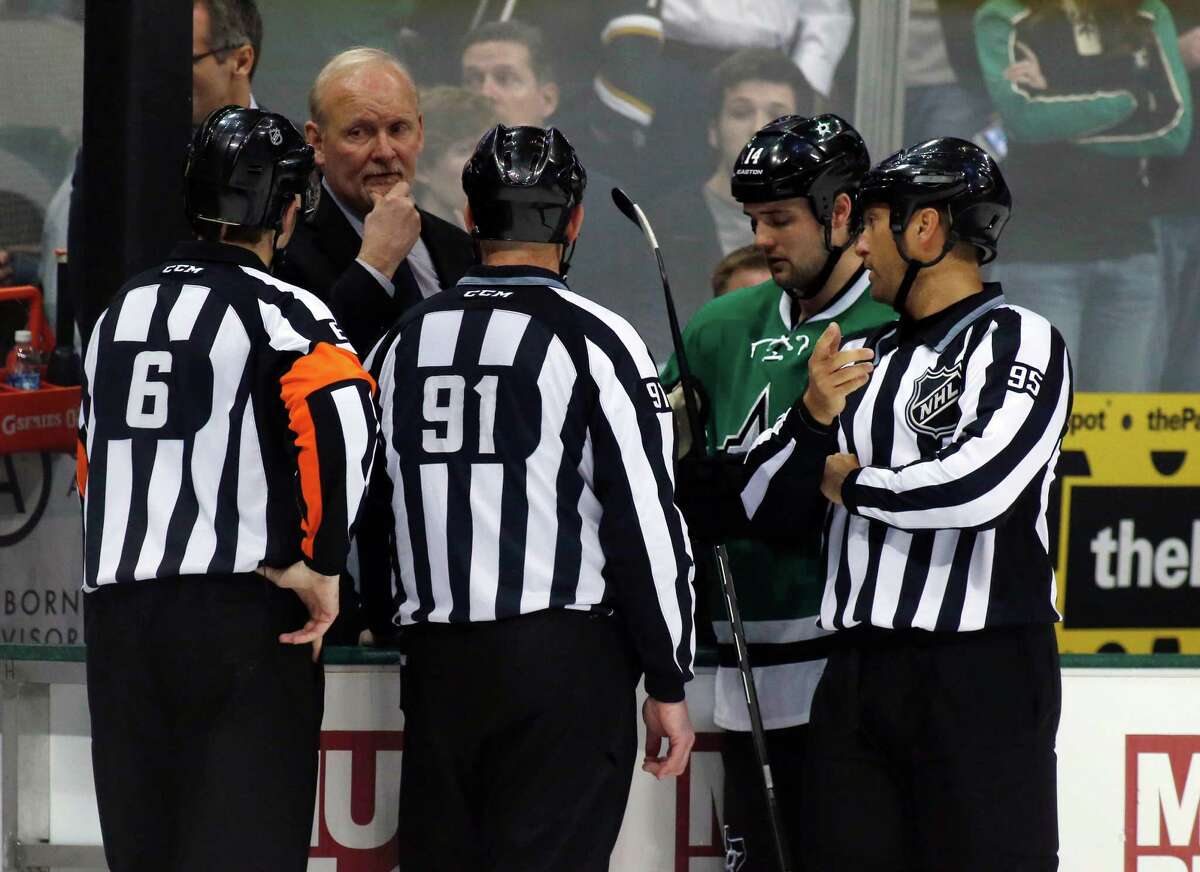 Dallas Stars head coach Lindy Ruff and center Jamie Benn talk to the referees Francis Charron (6), Don Henderson (91) and Jonny Murray (95) after play was stopped in the first period of an NHL Hockey game against the Columbus Blue Jackets Monday, March 10, 2014, in Dallas. Center Rich Peverly was taken to a hospital after a medical emergency. (AP Photo/Sharon Ellman)