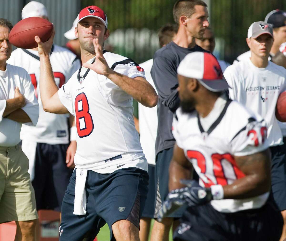 Texans quarterback Matt Schaub (8) reaches back to throw a pass with running back Ahman Green (30) in the foreground during Texans training camp Thursday, Aug. 7, 2008, in Houston.