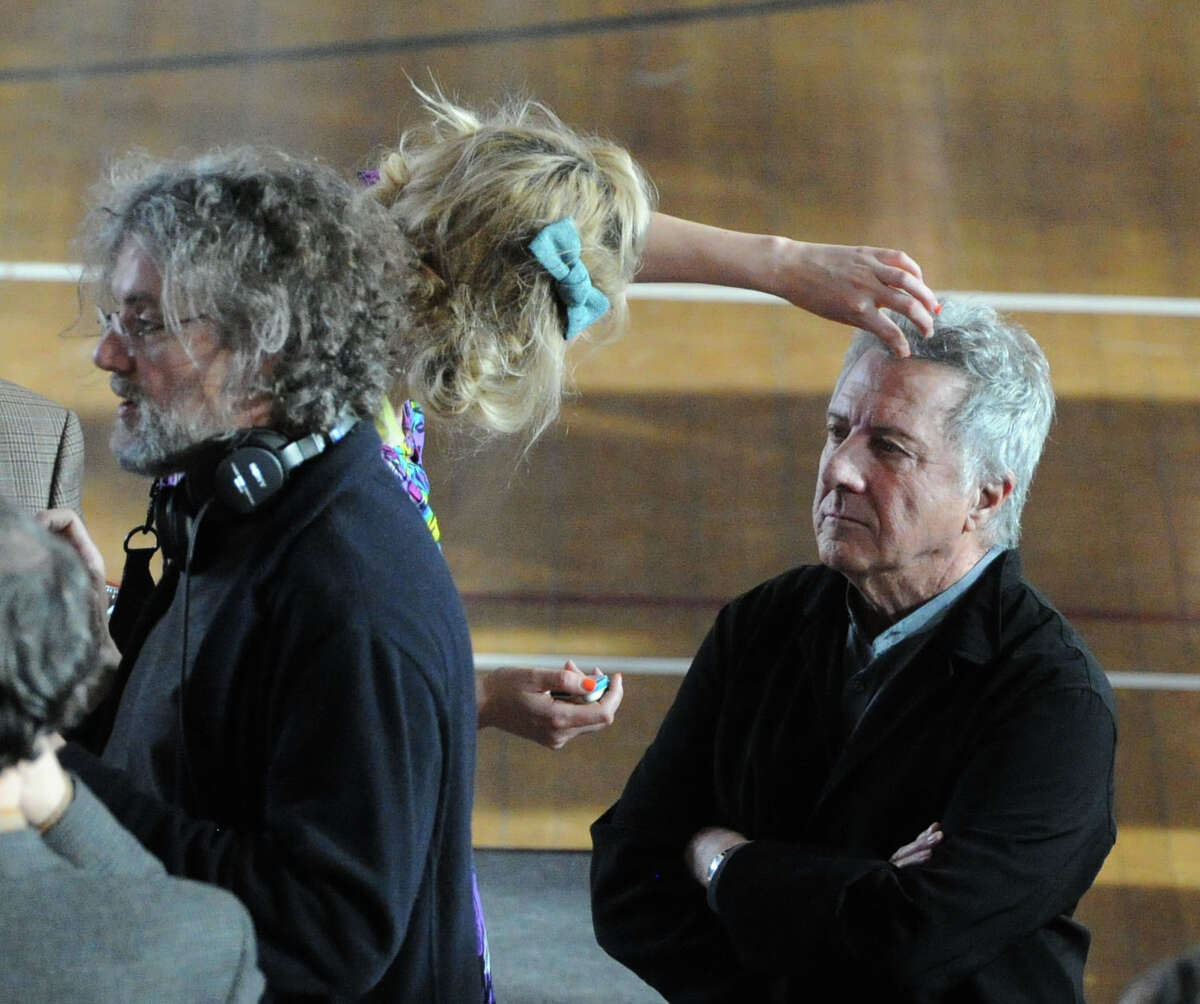 Actor Dustin Hoffman, right, gets makeup applied to his face on the set of "Boychoir," that was filming at the Greenwich Civic Center in Old Greenwich, Conn.,Tuesday afternoon, March 11, 2014. At left is the film's Director, Francois Girard.