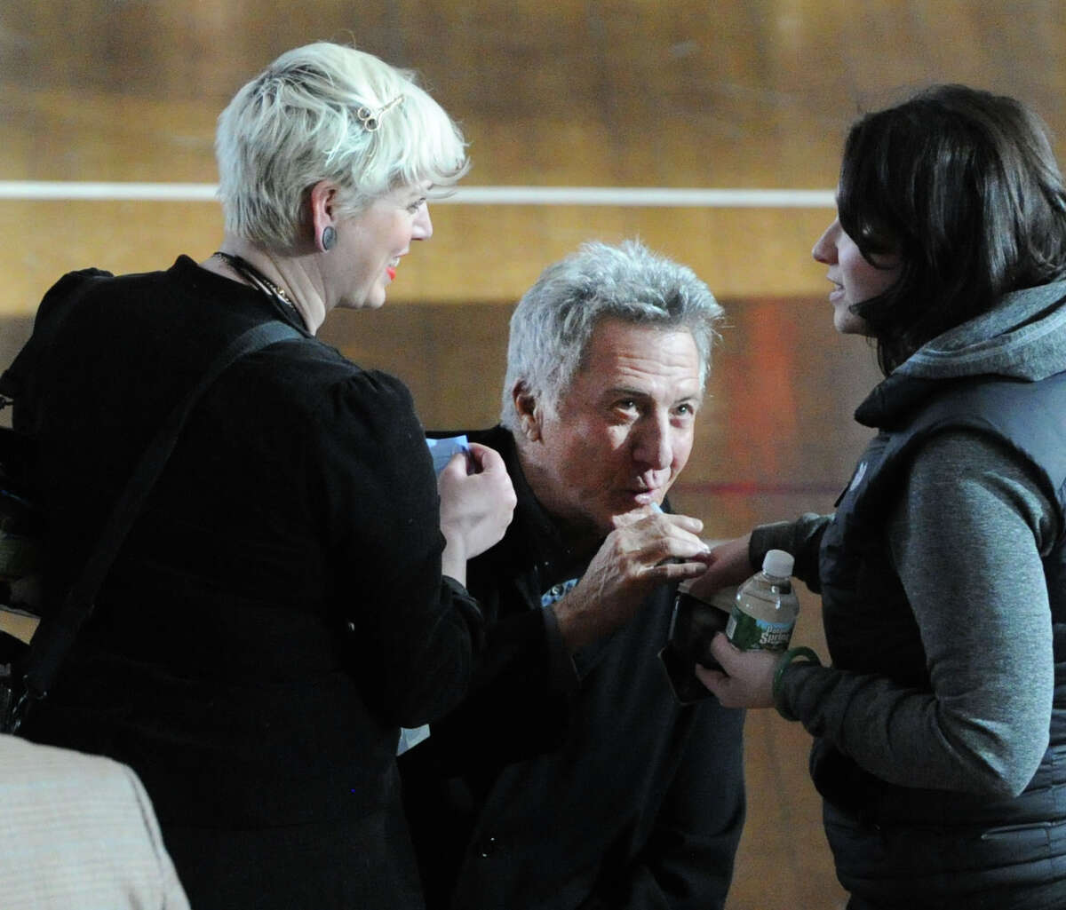 Actor Dustin Hoffman, center, takes a drink of a beverage on the set of "Boychoir," that was filming at the Greenwich Civic Center in Old Greenwich, Conn.,Tuesday afternoon, March 11, 2014.