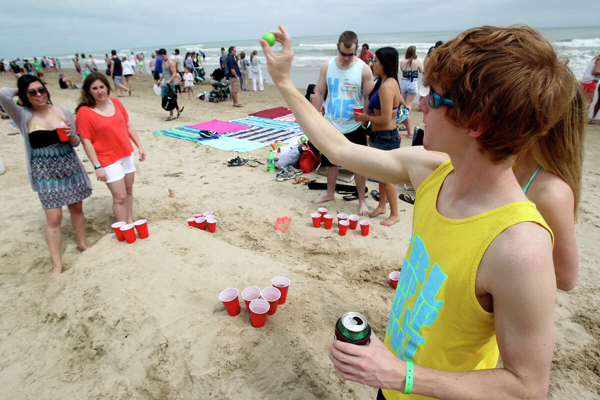 Chase Kaiser, an Aggie, plays some beer pong during Spring Break 2014 on the South Padre Island beach near Clayton's on March 11, 2014.