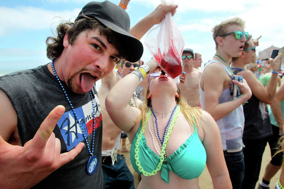 College students pass around a liquid to drink during Spring Break 2014 on ...