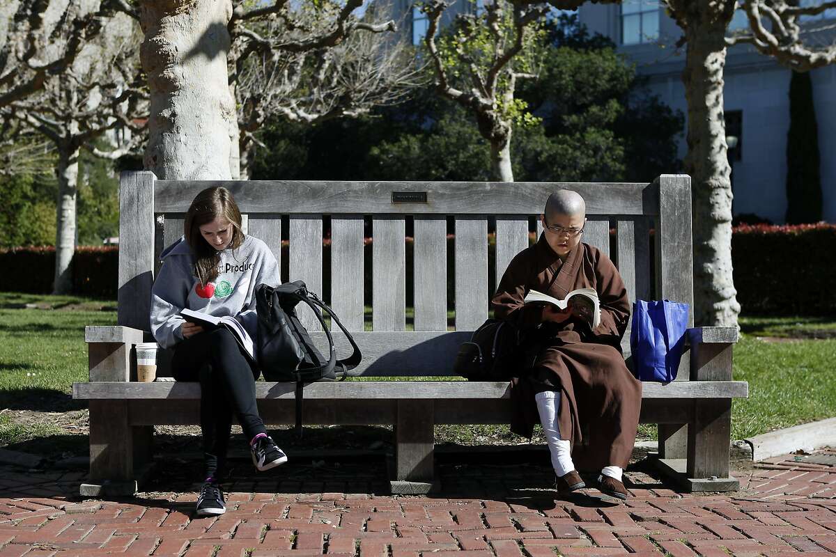 Senior Haley Keltner, left, and junior Jai Chen share a bench while studying between classes on the Cal campus in Berkeley, CA, Tuesday, March 11, 2014. State legislature is considering restoring the ability of California universities to use race and ethnicity in admissions decisions.