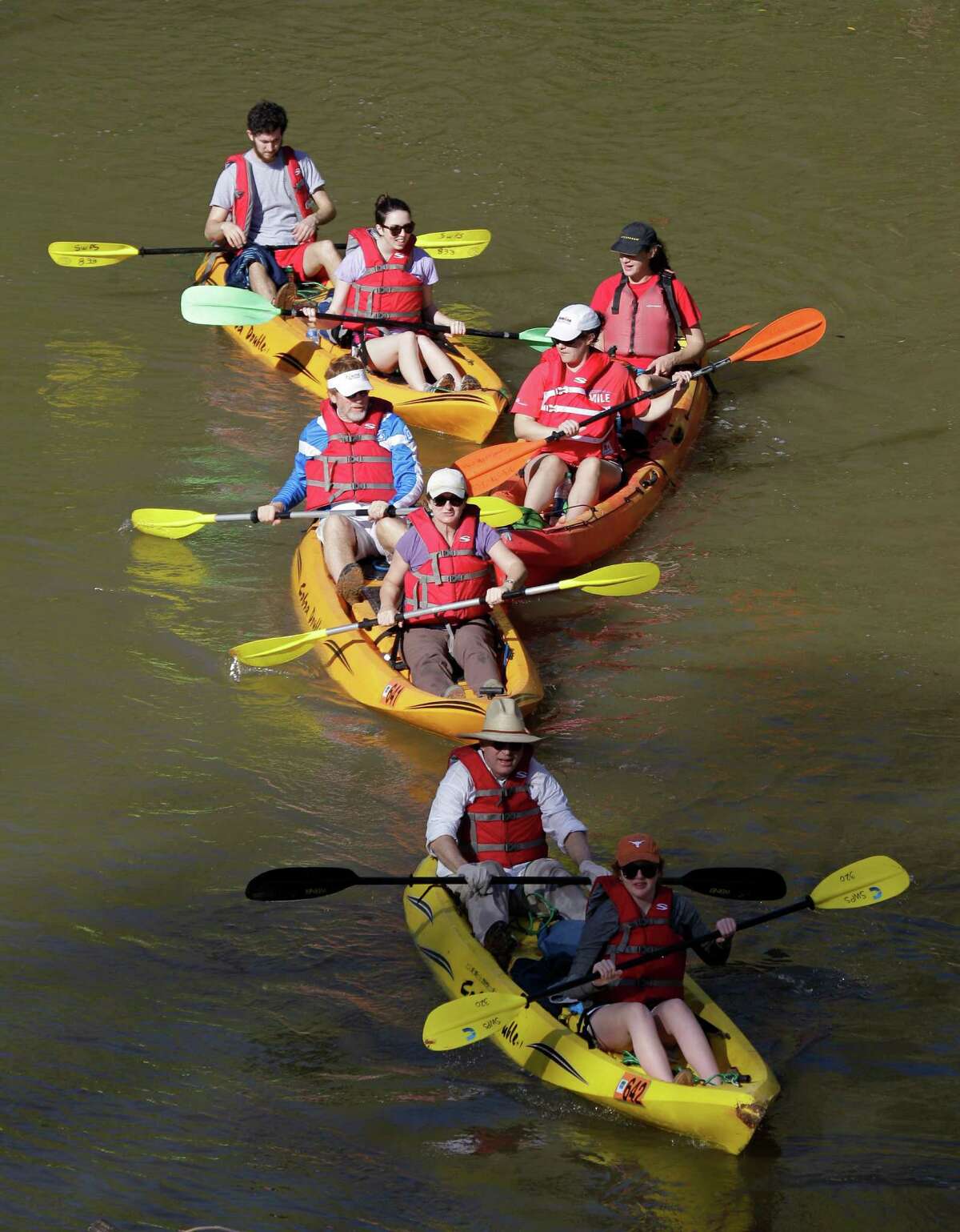 People paddle along during the Buffalo Bayou Regatta Saturday, March 16, 2013 in Houston. At least 500 boats are participating in the 15 mile race. (Melissa Phillip / Houston Chronicle)