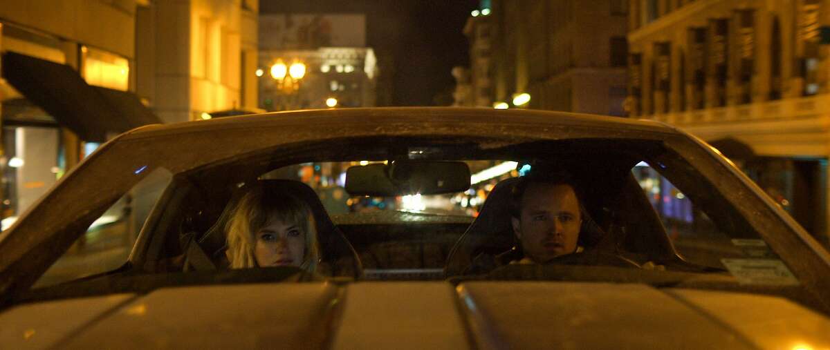 06102914 Tobey Marshall (Aaron Paul) and Julia Maddon (Imogen Poots) have less than 45 hours to race from New York to California in DreamWorks Pictures' "Need for Speed", an exciting return to the great car culture films of the 1960s and '70s that tap into what makes the American myth of the open road so enticing.