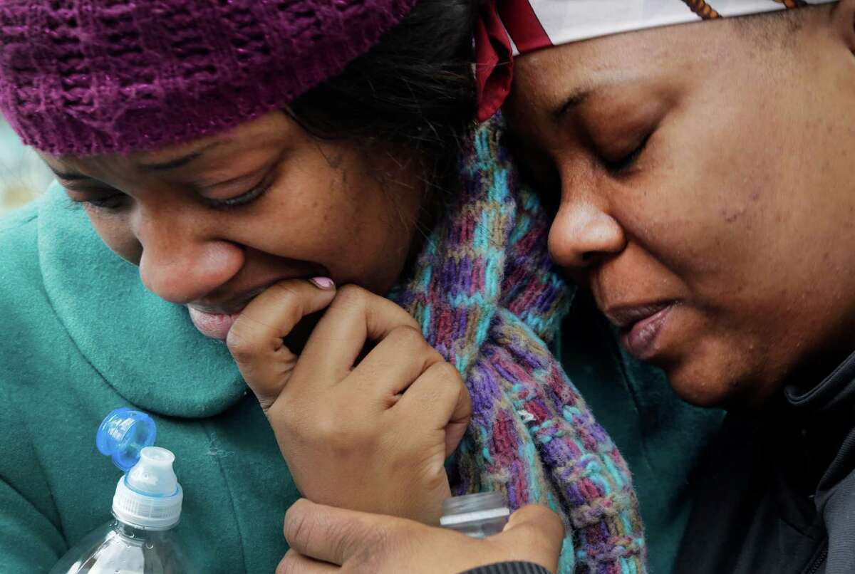 Alecia Thomas, left, is comforted by her friend, Shivon Dollar, after she lost her home following an explosion that leveled two apartment buildings in the East Harlem neighborhood of New York, Wednesday, March 12, 2014. Con Edison spokesman Bob McGee says a resident from a building adjacent to the two that collapsed reported that he smelled gas inside his apartment, but thought the odor could be coming from outside. (AP Photo/Mark Lennihan) ORG XMIT: NYML106