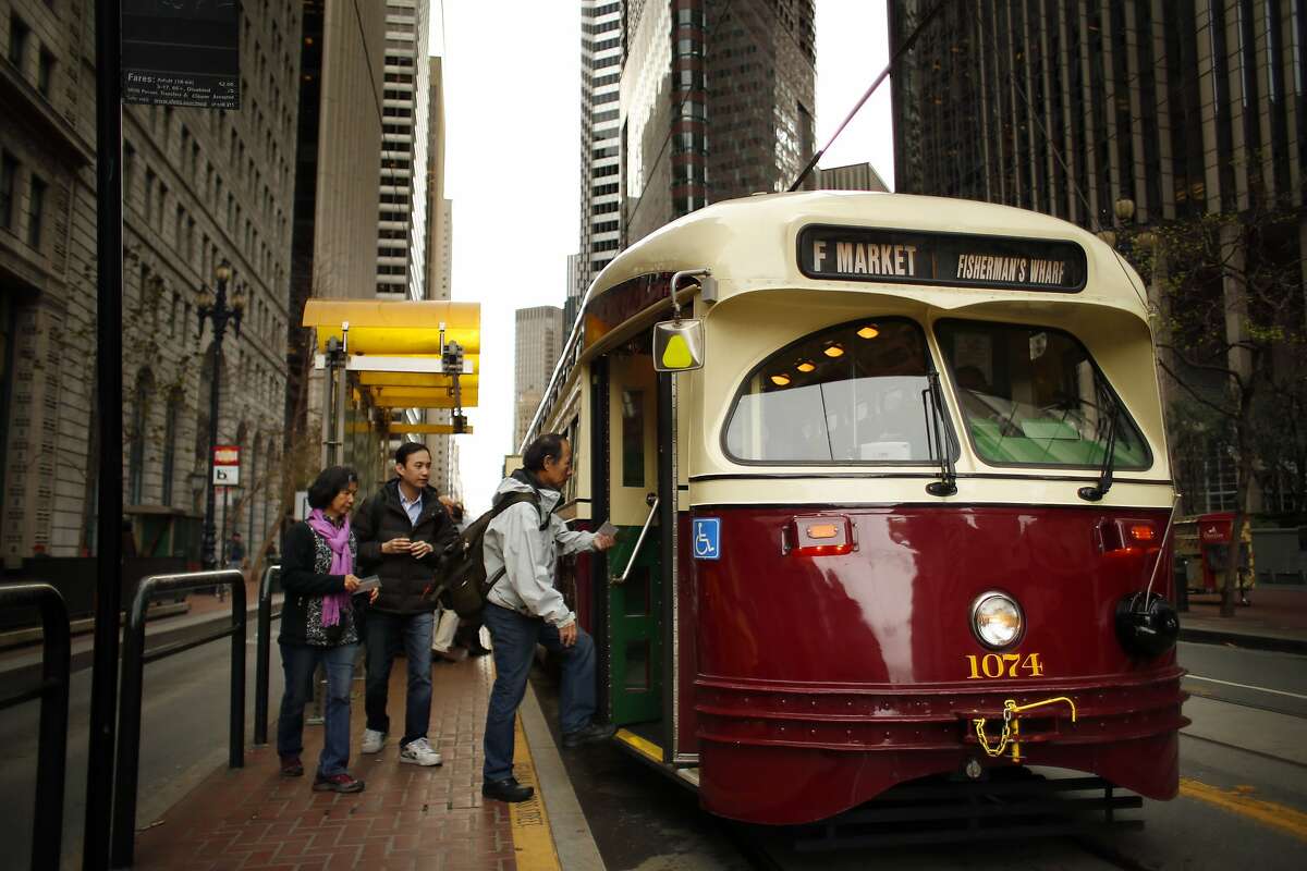 Passengers board an F Line Muni streetcar on Market Street in San Francisco, Calif., on Wednesday, March 5, 2014. Muni F Line of historic streetcars is popular with both tourists who tour the city and locals who use them for commute. But there is a suggestion that fares might go up to a premium rate of $6 like the Cable Cars, instead of the standard Muni $2 fare that is paid today.