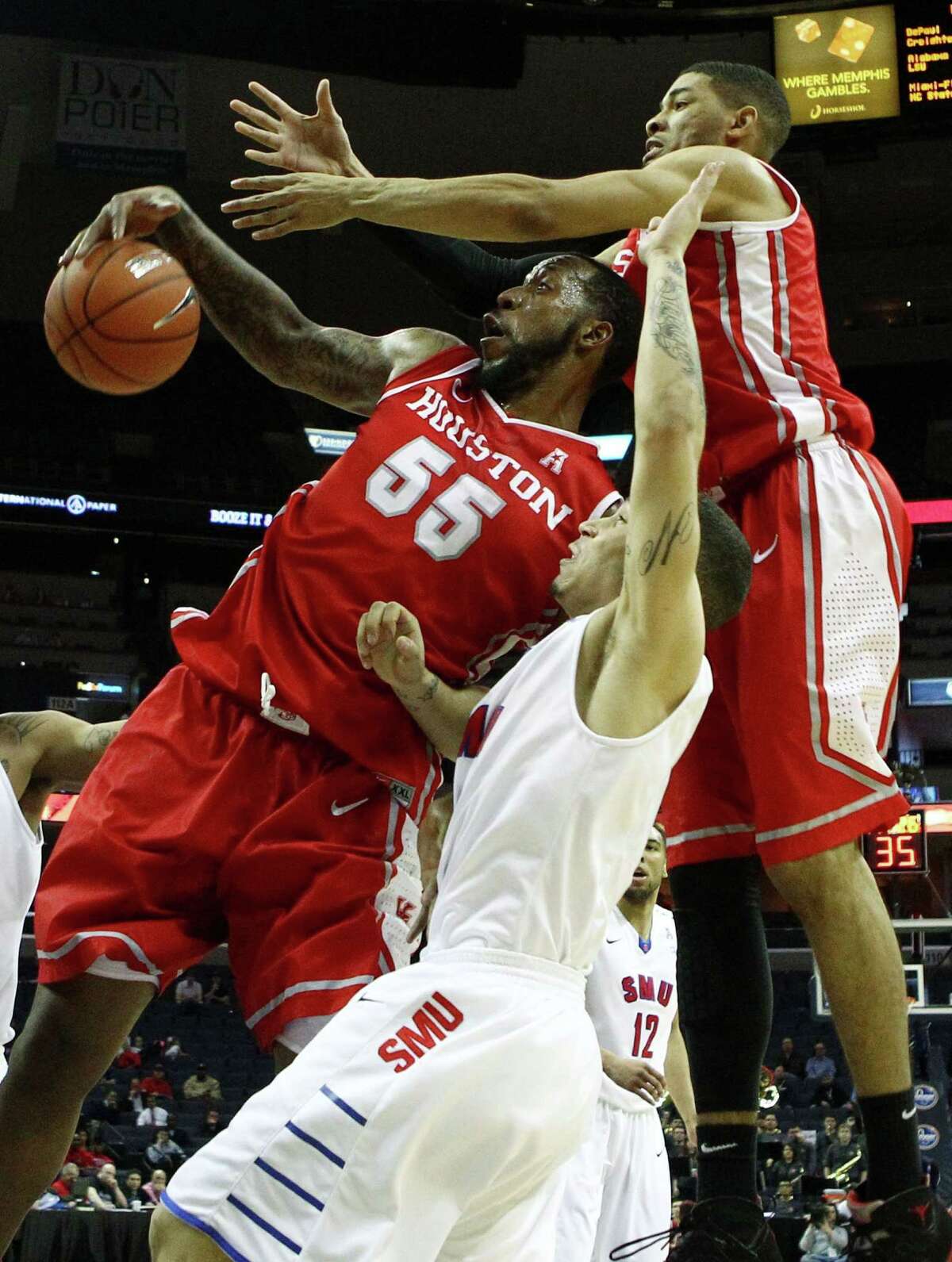 Houston Cougars forward J.J. Richardson (left), SMU Mustangs guard Nic Moore (center) and Houston Cougars guard LeRon Barnes (right) battle for a rebound during the quaterfinals of the American Athletic Conference tournament at FedExForum, March 13, 2014 in Memphis, Tenn. (Mike Brown/The Commercial Appeal/MCT)