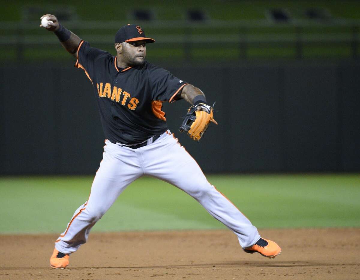 San Francisco Giants third baseman Pablo Sandoval (48) throws to first base for an out during the third inning against the Texas Rangers at Surprise Stadium.