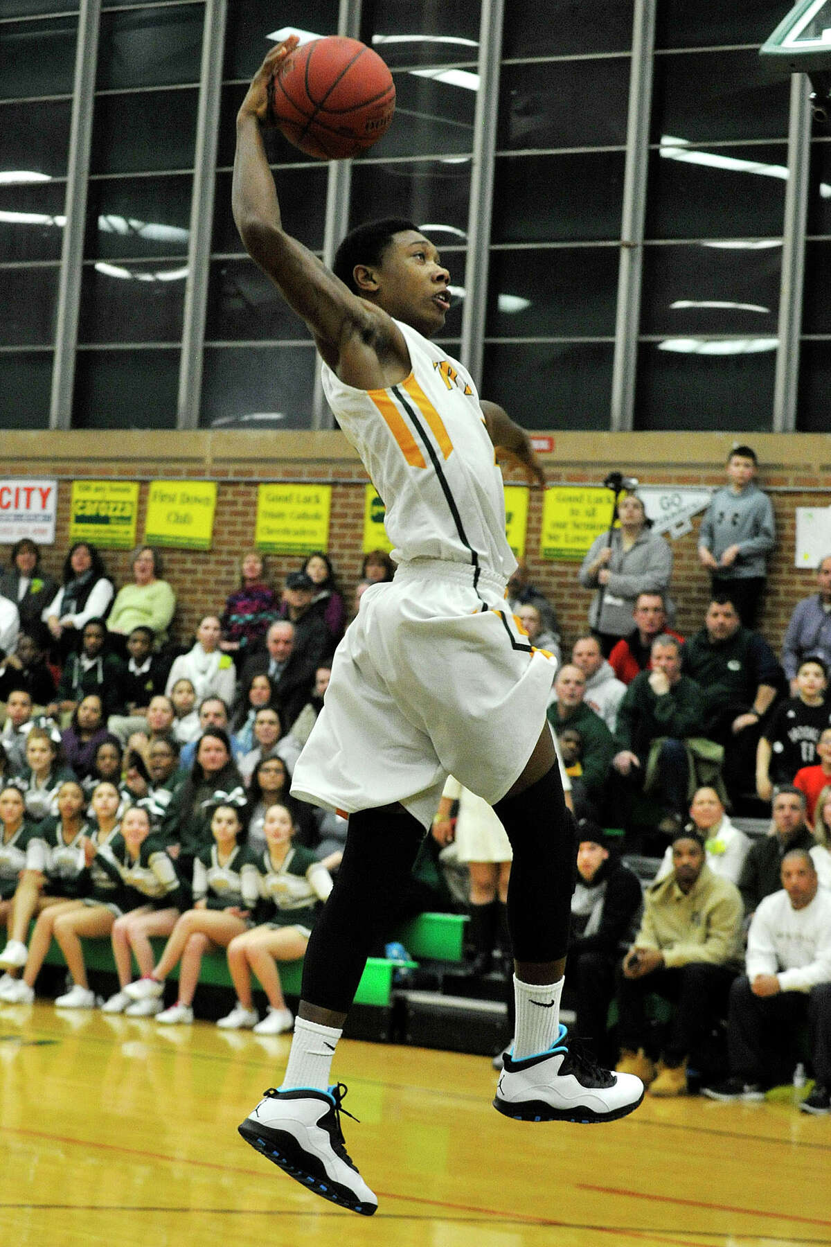Trinity Catholic's Tremaine Fraiser dunks the ball during their game against Westhill at Trinity Catholic High School in Stamford, Conn., on Wednesday, Feb. 26, 2014. Westhill won, 67-63.