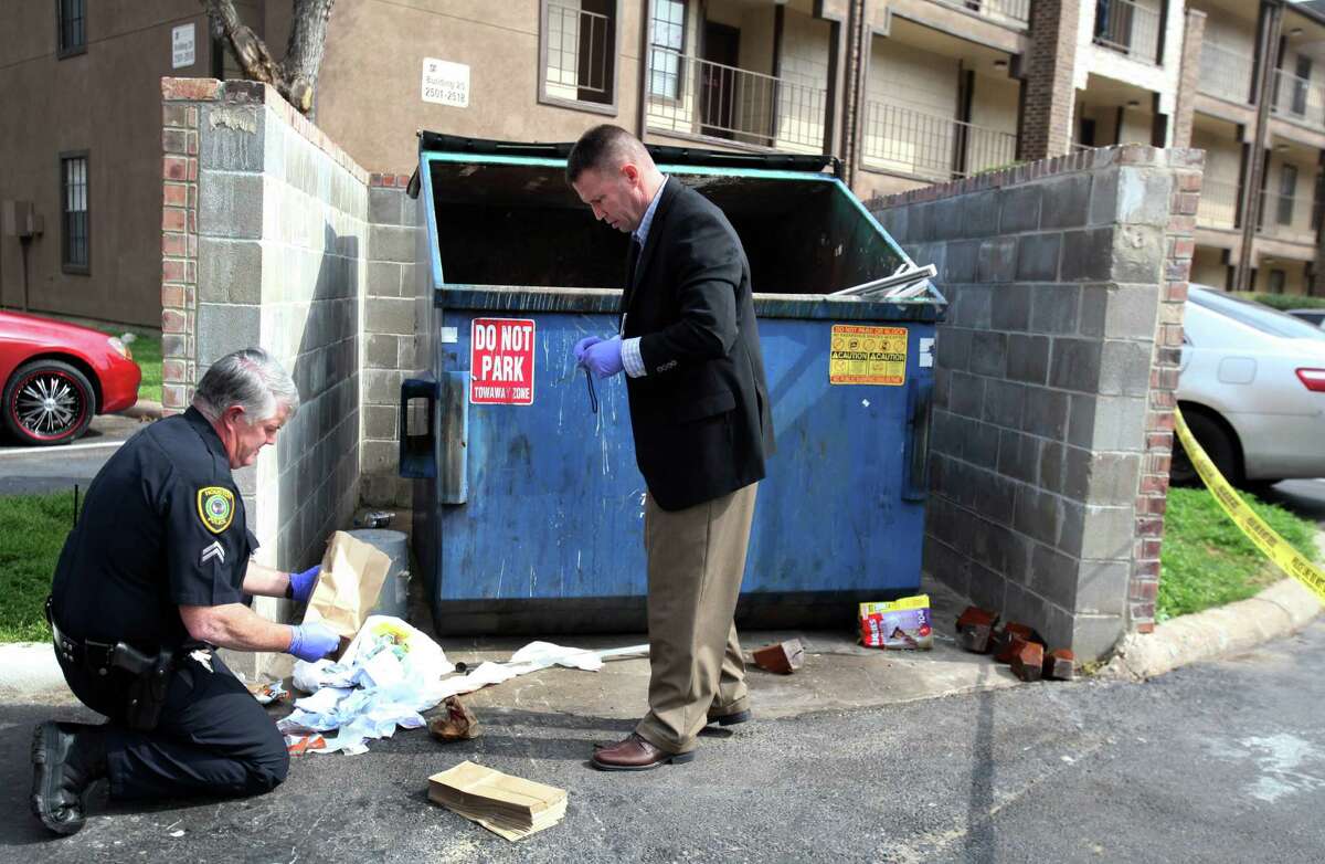 HPD works the scene where a newborn baby boy was found alive in a dumpster by maintenance worker Carlos Michel on Feb. 25, 2014, in Houston. According to Carlos Michel, maintenance worker at The Reserve at Windmill Lakes Apartment complex, he heard a sound coming from the dumpster which he thought it was a cat at first. When he heard sound again, after throwing a bucket of trash in the dumpster, he reached in and pulled a white trash bag with a newborn baby inside. ( Mayra Beltran / Houston Chronicle )