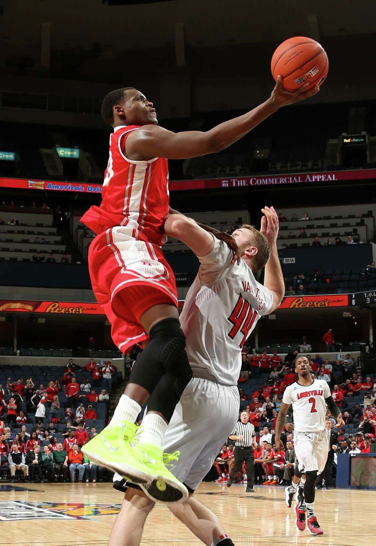 MEMPHIS, TN - MARCH 14: Danuel House #23 of the Houston Cougars drives to the basket against Stephan Van Treese #44 of the Louisville Cardinals during the semifinals of the American Athletic Conference Tournament at FedExForum on March 14, 2014 in Memphis, Tennessee.