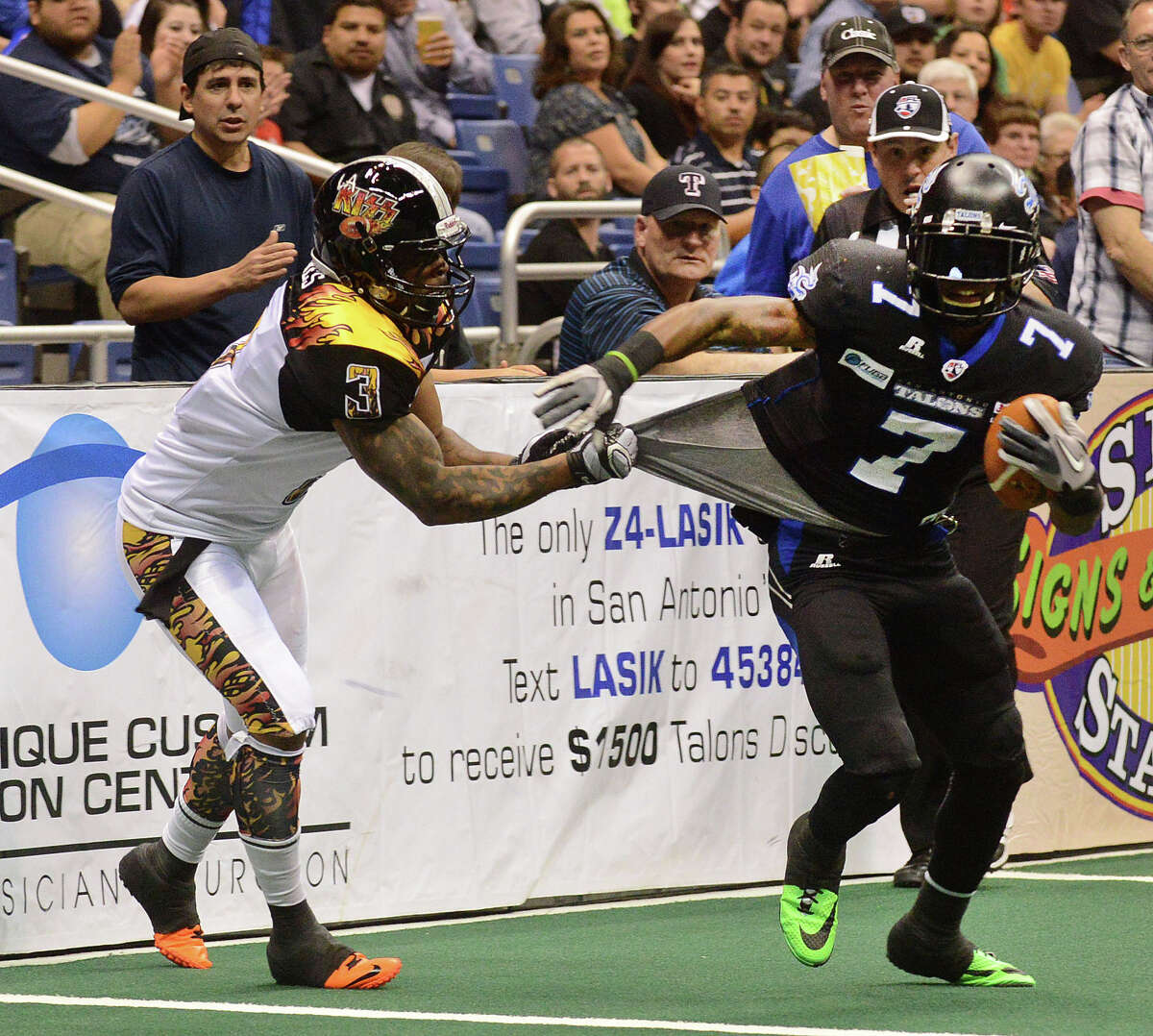 Receiver D.J. Stephens of the San Antonio Talons attempts to get away from Andre Jones of the Los Angeles KISS during Arena Football League action in the Alamodome on Saturday, March 15, 2014.