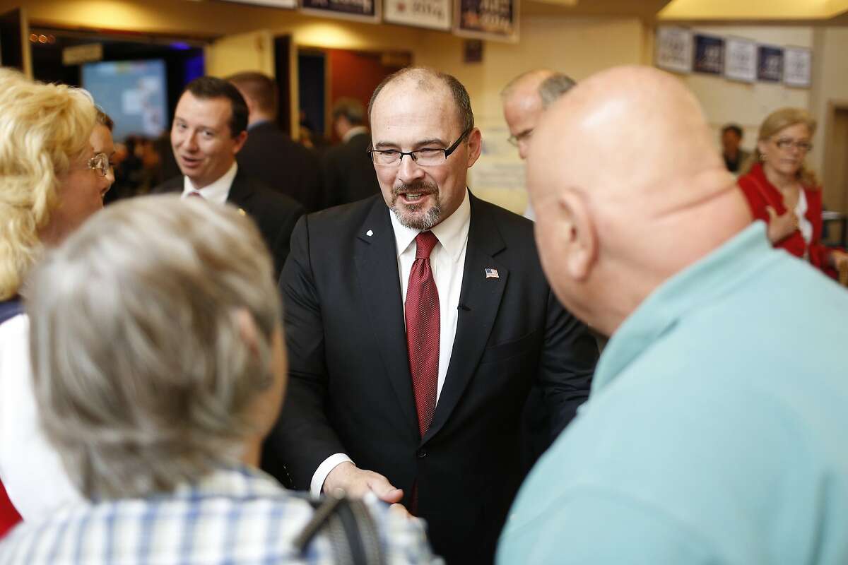 California Republican gubernatorial primary candidate Tim Donnelly (C) greets a well-wisher after delivering a speech at the California Republican Party Spring Convention in Burlingame, California March 16, 2014 REUTERS/Stephen Lam (UNITED STATES - Tags: POLITICS)