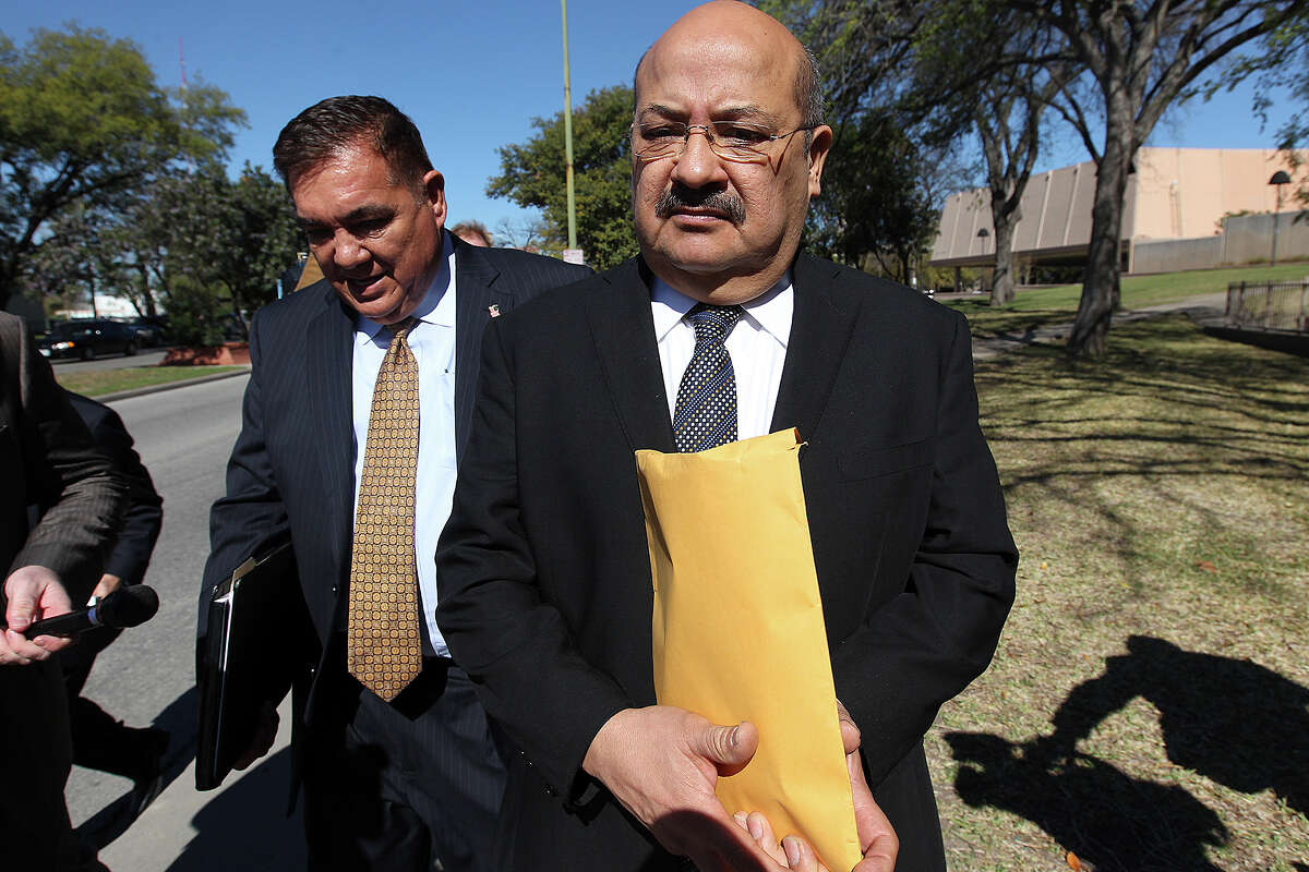 San Antonio attorney Al Acevedo, Jr, right, and his attorney Frank Perez, leave the U.S. Federal Courthouse after Acevedo plead guilty on charges of bribing a state district judge, Monday, March 17, 2014.