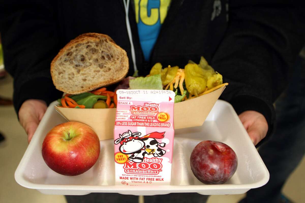FOR USE IN WEEKEND EDITIONS OCT. 13-14 - In this undated photo, a Naugatuck High School student displays his lunch that includes a large salad, whole grain bread, two fruits and fat free milk, in Naugatuck, Conn. Schools are putting more fruits and vegetables on their menus, but those healthy foods aren't necessarily ending up in students' stomachs. New federal guidelines say students must take one cup of fruit or vegetables, one cup of milk, two ounces of whole grains, and two ounces of meat or other protein. (AP Photo/The Republican-American, Laraine Weschler)