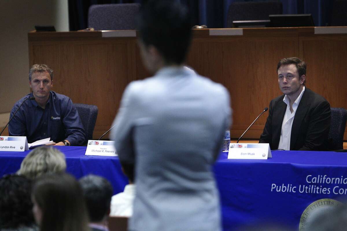 Lyndon Rive (l to r), co-founder and CEO of SolarCity and Elon Musk, co-founder and CEO of Tesla and founder and CEO of Space Exploration Technologies, listen to a question from the audience as they speak on a panel during a California Public Utilities Commission Thought Leader session in the CPUC Auditorium on Thursday, February 27, 2014 in San Francisco, Calif.