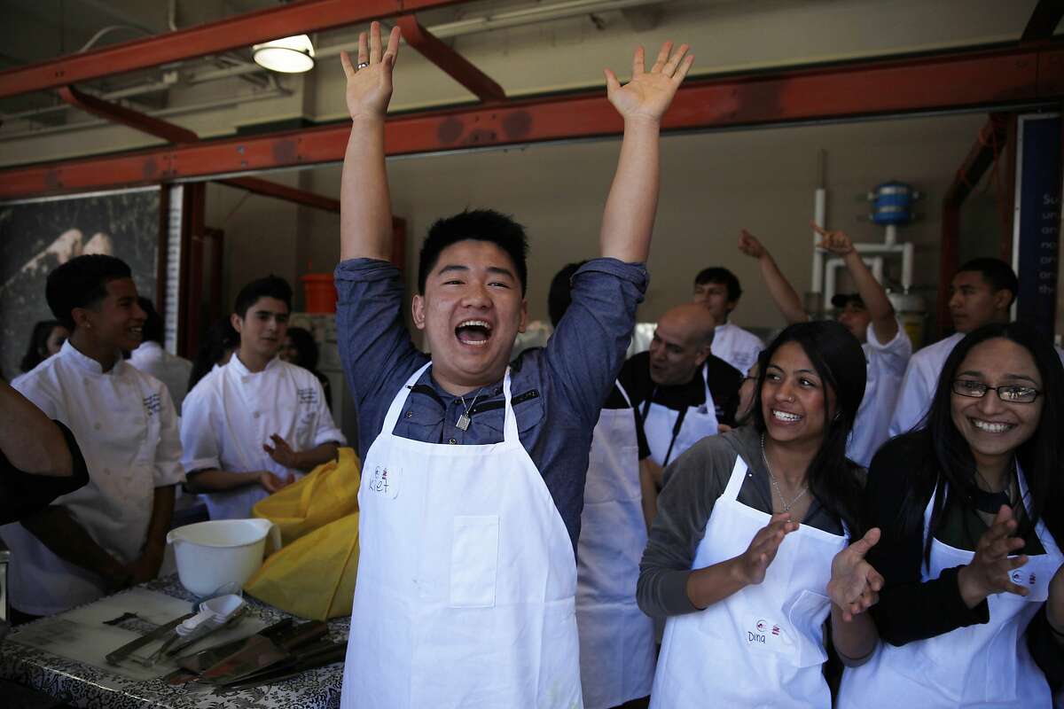 Kiet Huynh, 18, Galileo High School senior, raises his hands in the air after it was announced that the chicken dish the team he was on took the award for best tasting as students from San Francisco's Galileo High School and Concord's Mt. Diablo High School competed in The Bay Bridge Teens Cook with Heart Challenge at the Ferry Building on Monday, March 17, 2014, in San Francisco, Calif.