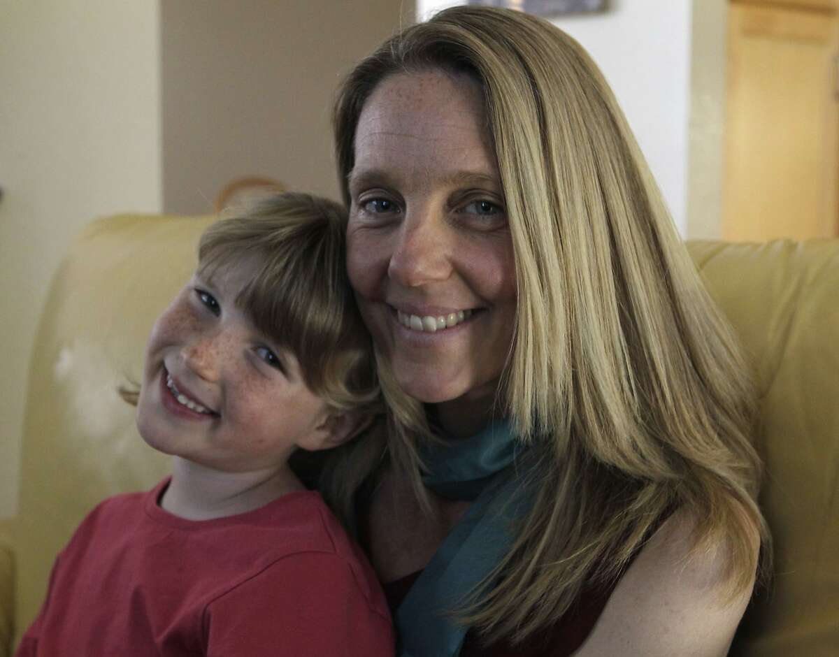 Seven-year-old Brooke Reid sits with her mother Katherine at their home in Fremont, Calif. on Wednesday, March 12, 2014. Katherine Reid completely changed Brooke's diet as a way to control her autism.