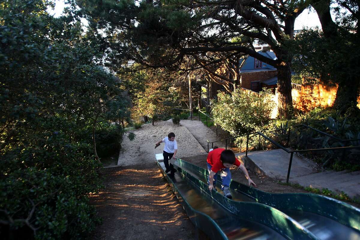 The Winfield Street slides are entirely hidden by trees. This steep joy ride can be found near Winfield Street and Esmeralda Avenue in Bernal Heights. Pictured: 8-year-old Darragh Long (right) and 8-year-old Michael Cordobes (left), from San Francisco walk up the slides on January 15, 2009. Google map