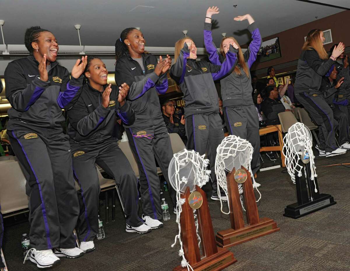 The University at Albany women's basketball team reacts as they find out they're playing West Virginia at Baton Rouge in the NCAA Tournament during a selection show party at the SEFCU arena on Monday, March 17, 2014 in Albany, N.Y. Pictured here from left are Zaklya Saunders, Jessica Fequiere, Bose Aiyalogbe, Erin Coughlin, Sarah Royals, Megan Craig, Shereesha Richards and Tammy Phillip. (Lori Van Buren / Times Union)
