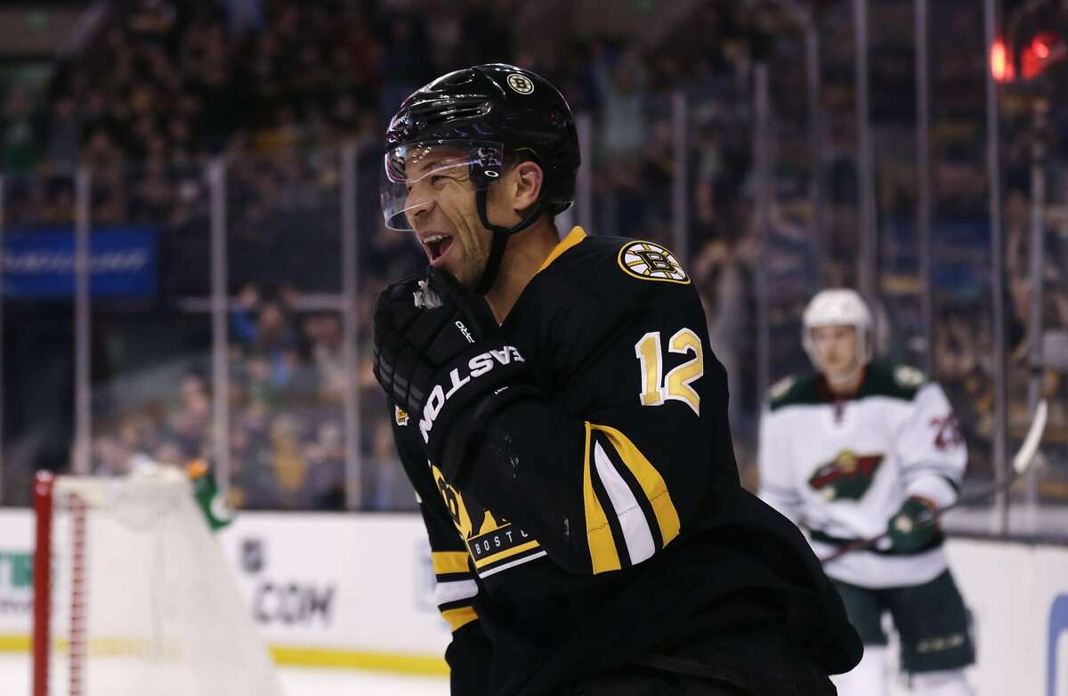 Boston Bruins right wing Jarome Iginla (12) smiles after his goal against the Minnesota Wild during the second period of an NHL hockey game, Monday, March 17, 2014, in Boston. Iginla had two goals in the Bruins 4-1 win. (AP Photo/Charles Krupa)