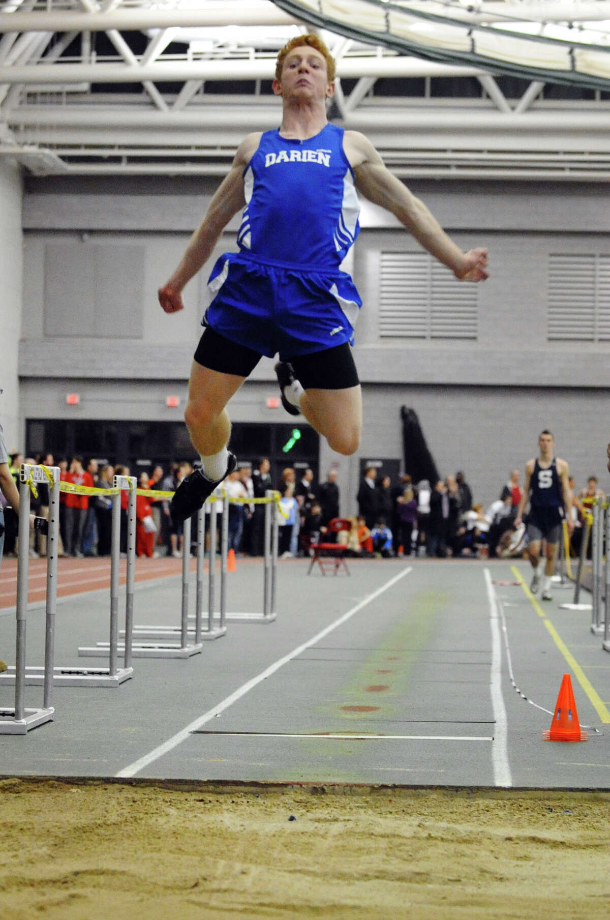 Darien's Nicholas Lombardo competes in the long jump event during FCIAC Indoor Track and Field Championships in New Haven on Thursday January 18, 2013.