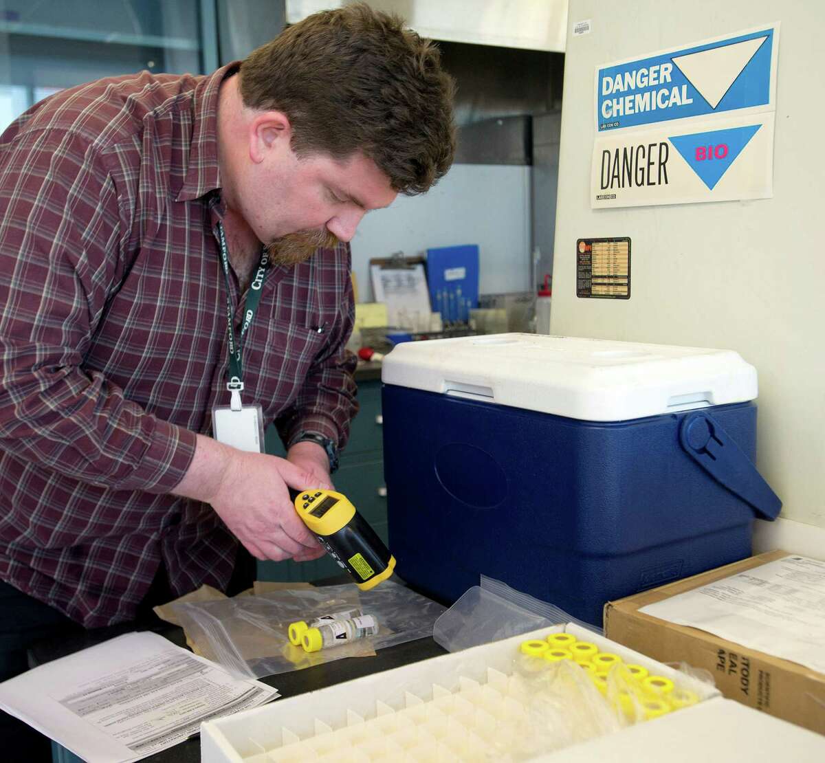 Jason Glenn labels well watersamples to be tested for pesticides, arsenic and uranium at the Heath Department Laboratory at Government Center in Stamford, Conn., on Tuesday, March 18, 2014.