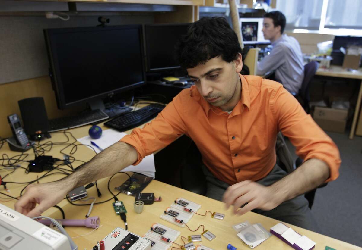 Mozziyar Etemadi works on a smart diaphragm device with Alex Heller (background) in San Francisco, Calif. on Friday, March 14, 2014. The team of engineers at the UCSF Mission Bay campus are developing a wireless device that they hope will detect early signs of pre-term births in pregnant women.