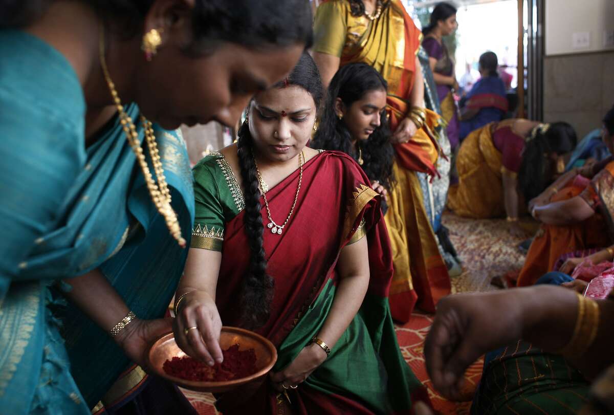 Tulasi Gurrala takes part in a Sri Lalitha Sahasranama Archana ceremony by applying a bindi to another devotee at Shiva-Vishnu Temple on March 15, 2014 in Livermore, Calif.