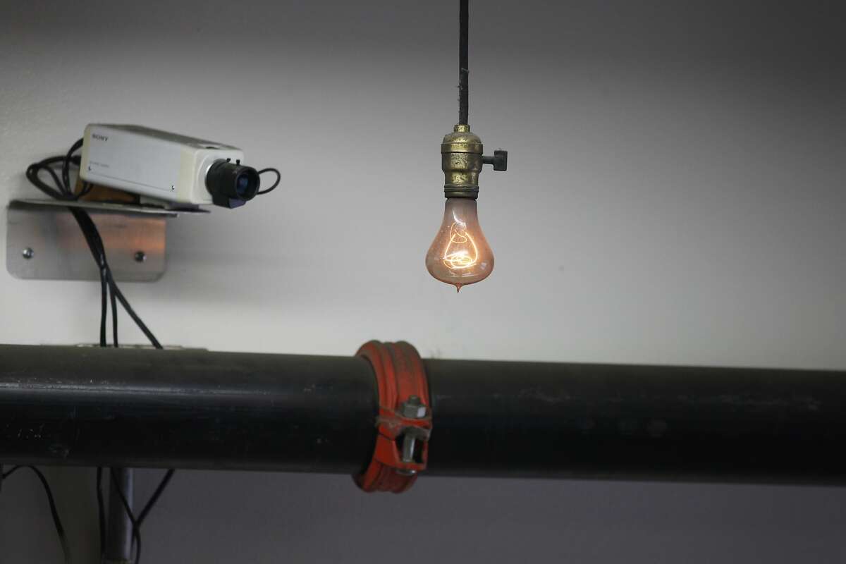 The world's longest-burning lightbulb is seen at Fire Station #6 on March 13, 2014 in Livermore, Calif. At left is a webcam, via which viewers may watch the light bulb at any time. The lightbulb has been burning, with a few minor interruptions, for 112 years as of June 2013.