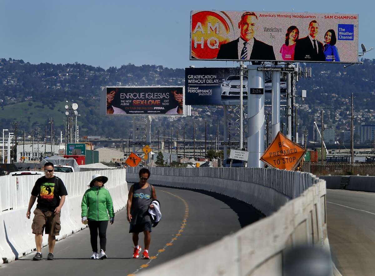 Looking east, the three billboards loom above the new Bay Bridge Trail Monday March 17, 2014. The three large illuminated billboards on the east end of the Bay Bridge could be joined by more. The city of Oakland has approved five more but CALTRANS has reportedly rejected some of them.