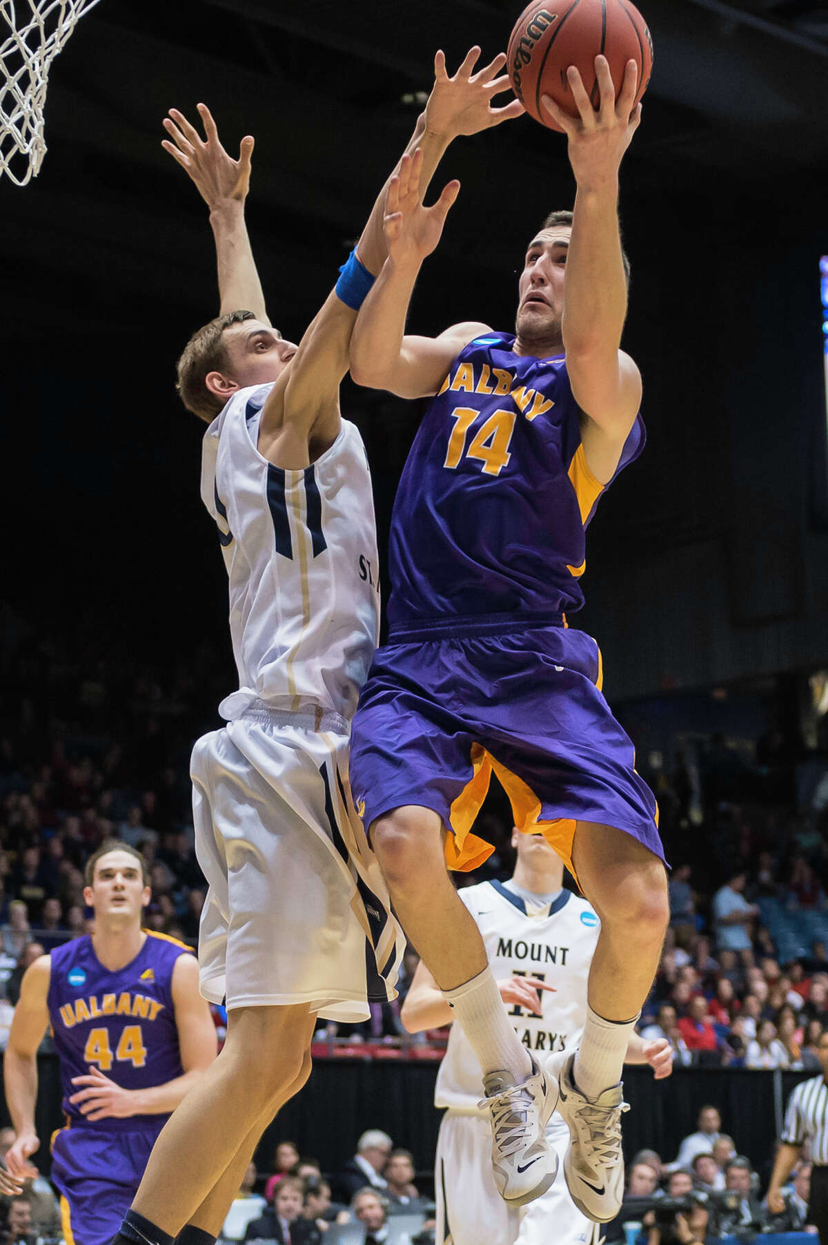 UAlbany Great Danes forward Sam Rowley (14) right puts up a shot from the paint with Mount St Mary's Mountaineers center Taylor Danaher (50) left defending during the NCAA first round game, Tuesday night, Mar. 18, 2014, in Dayton, O.H. (Gregory Fisher/Special to the Times Union)