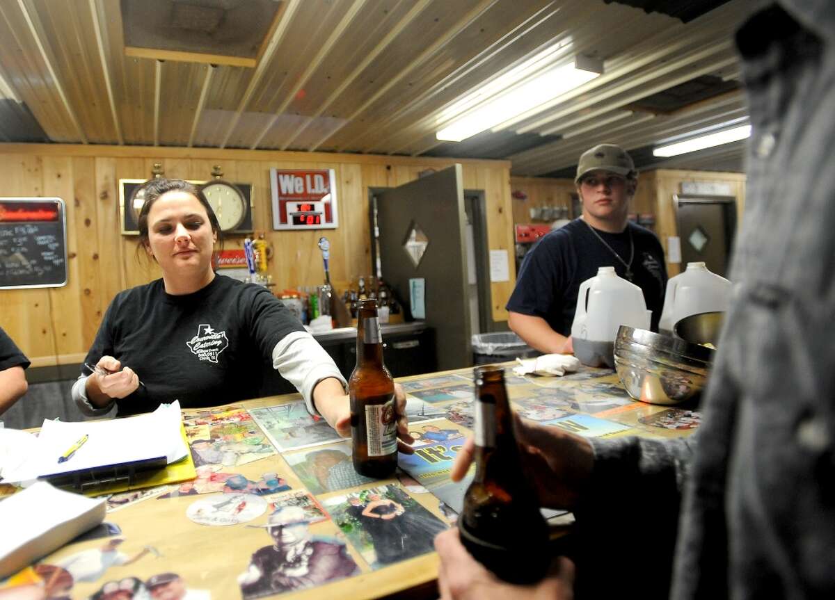 Paula Breaux serves a big from the bar at Big Rich Courville's in Beaumont, Thursday, December 1, 2011. Tammy McKinley/The Enterprise