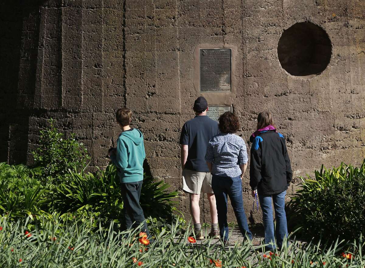 Visitors pause to read plaques at the base of the Dutch windmill at Golden Gate Park in San Francisco, Calif. on Wednesday, March 19, 2014. More funding is needed to renovate the windmill located on the northwest corner of the park.