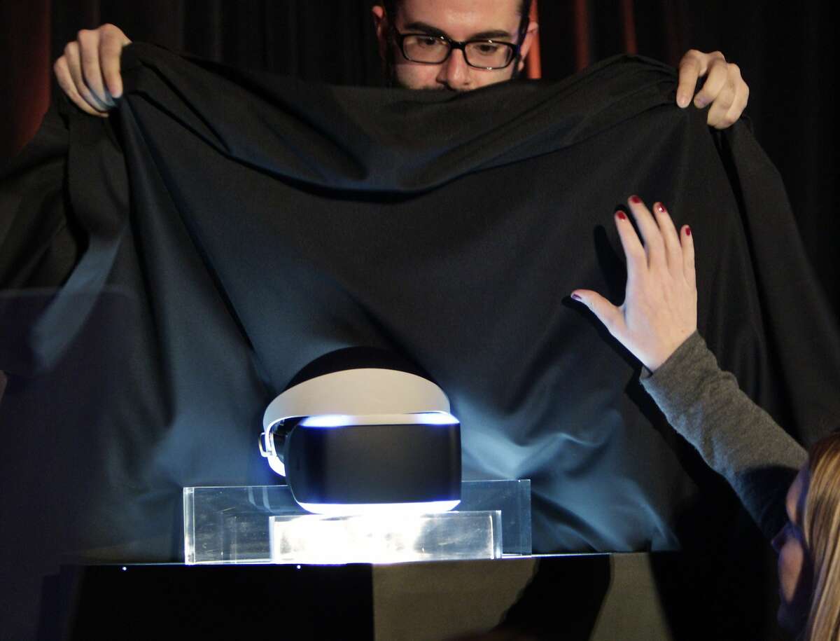 Sony staffers quickly cover the new Prometheus virtual reality headset at the end of the presentation announcing the device. Sony unveiled a prototype virtual reality headset on Tuesday, March 18, 2014, in San Francisco, Calif., during the Sony Game Developers Conference. The move signals Sony's leap into the race to sell virtual reality gaming gear. The prototype is code-named Morpheus and is made for the Playstation 4.