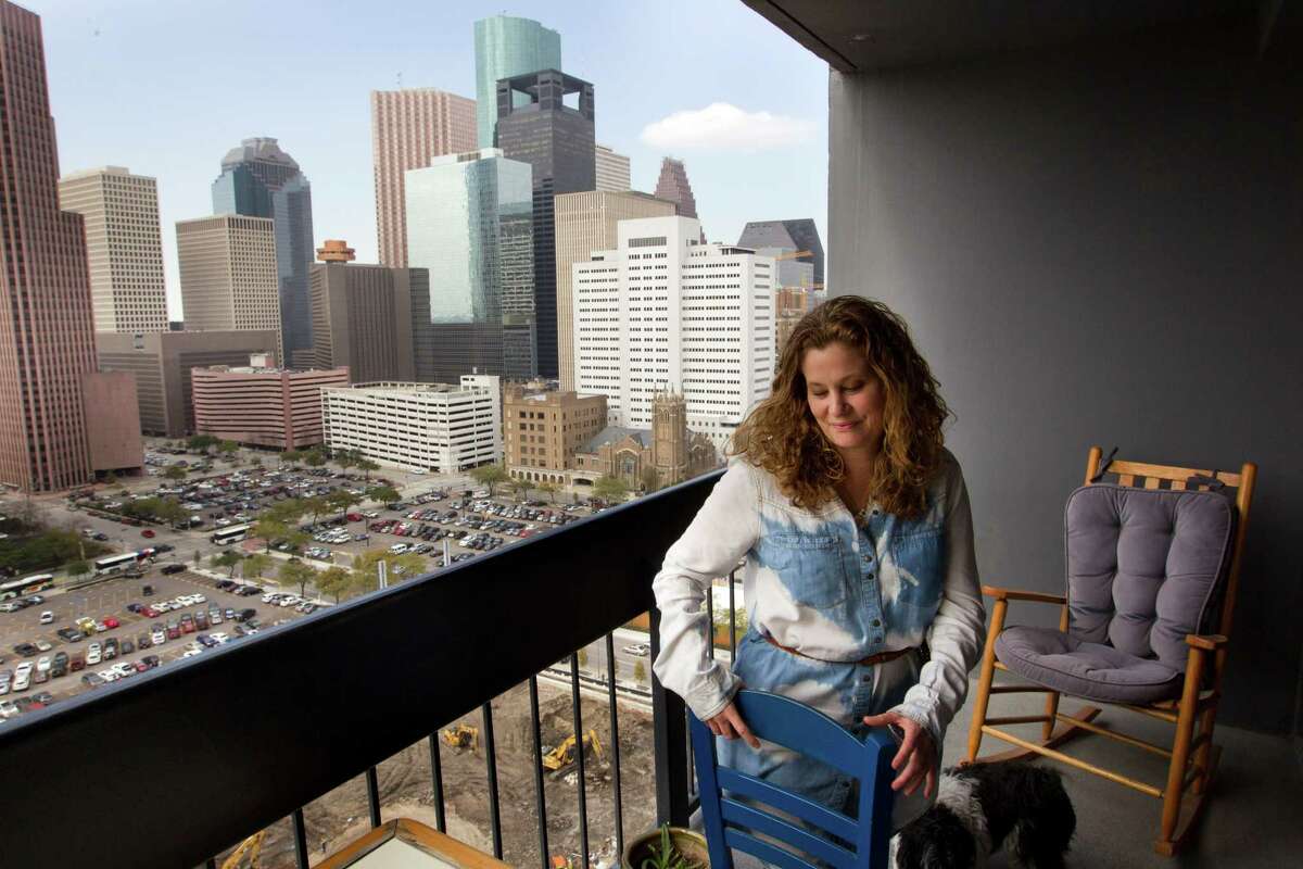Angela Touchstone has a grand vista of the Houston skyline from her balcony at Houston House Apartments, near the Toyota Cener. She moved there from the suburbs more than two years ago.