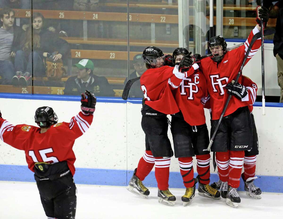 Fairfield Prep celebrate with team mate #22 Dean Lockery after Lockery first period action goal during Wednesday evening CIAC Division I Semi-Finals against Notre Dame of West Haven.