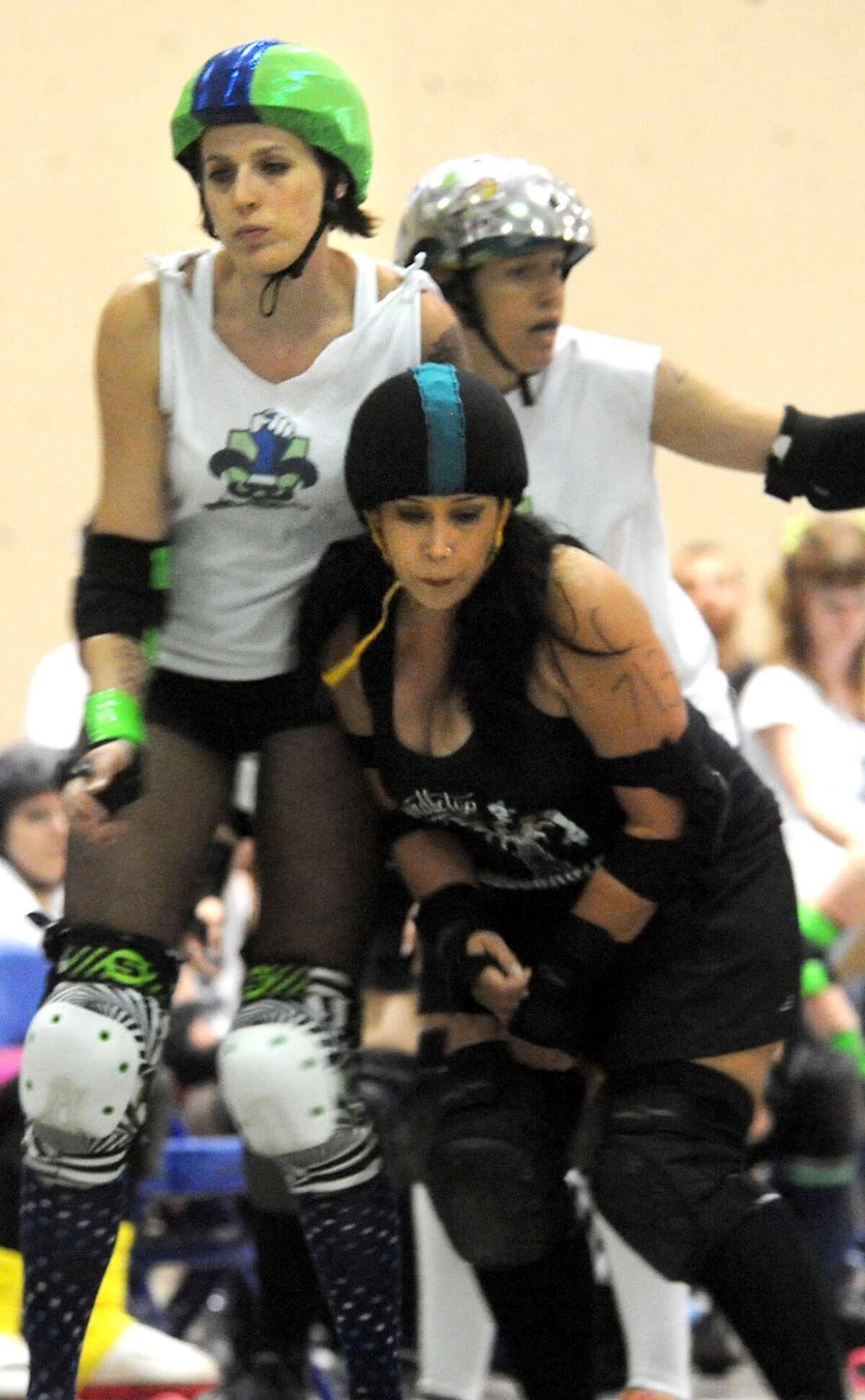 The Spindletop Roller Girls take on the Acadiana Good Times Rollers during the Spindletop Roller Girls first bout of the first season at Ford Exhibit Hall in Beaumont, Sunday. Tammy McKinley/ The Enterprise