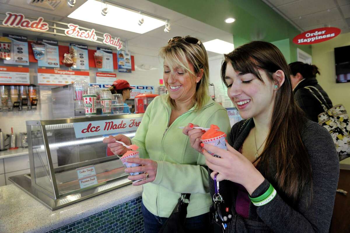 Jane Giambruno, left, and daughter, Jill Giambruno of Bethel, Conn., eat Italian ice at Rita's Italian Ice in Bethel, Thursday, March 20, 2014.