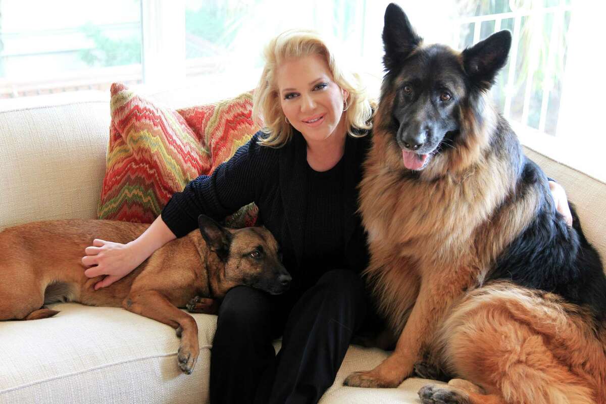 Kristi Schiller, with guard dogs Daisy and Johnny Cash, is the founder and chair of K9s4Cops and an offshoot, K9s4Kids, which works to beef up security at school campuses.